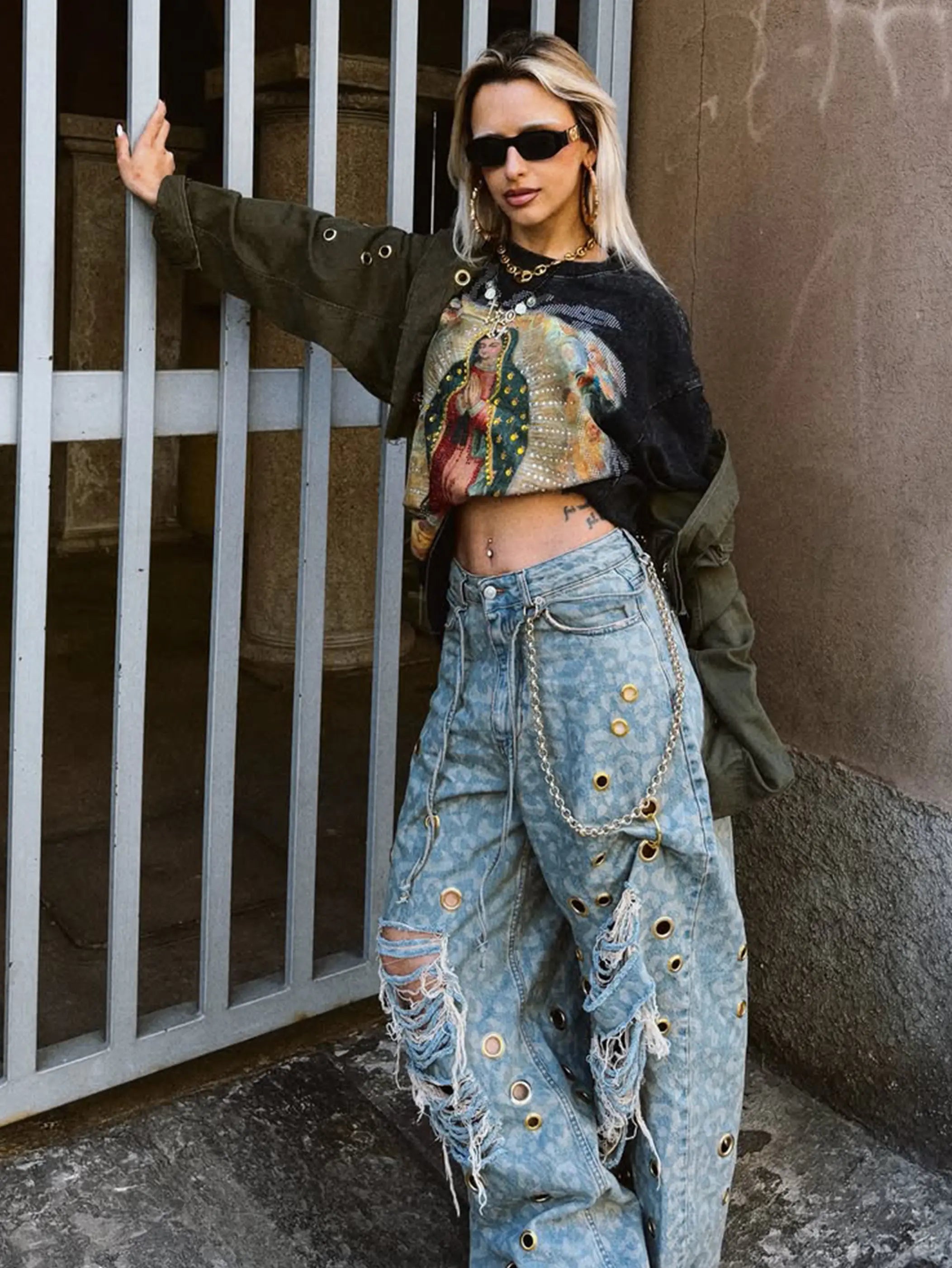 Black vintage religious graphic tee styled with distressed denim and layered accessories